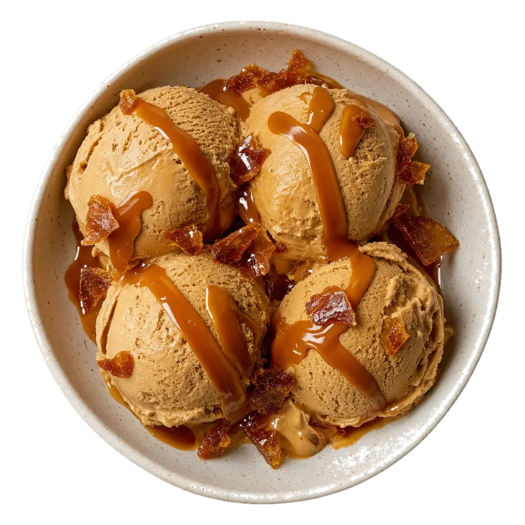 A bowl of dulce de leche gelato seen from above with caramel drizzled over it.