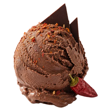 A scoop of dark chocolate gelato dusted with chilli flakes, with a red chilli beside it.