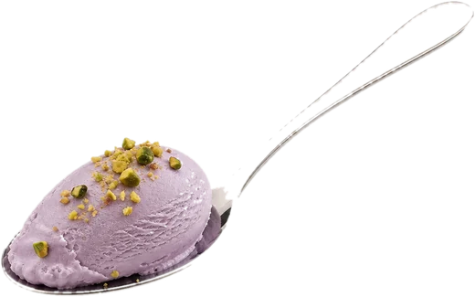 A silver spoon holding a small quenelle of pale violet gelato with crushed pistachios.